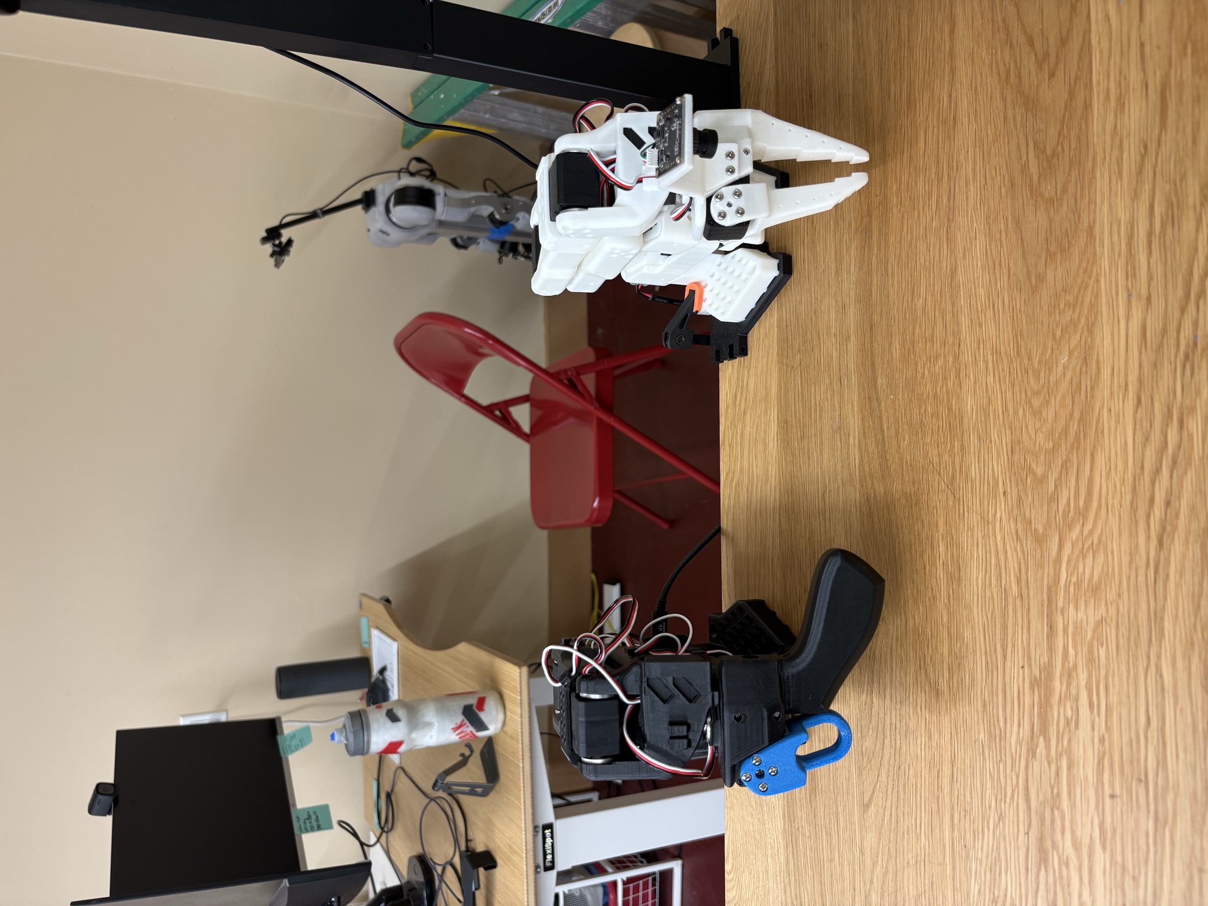 SO-101 leader and follower robot arms on the workbench